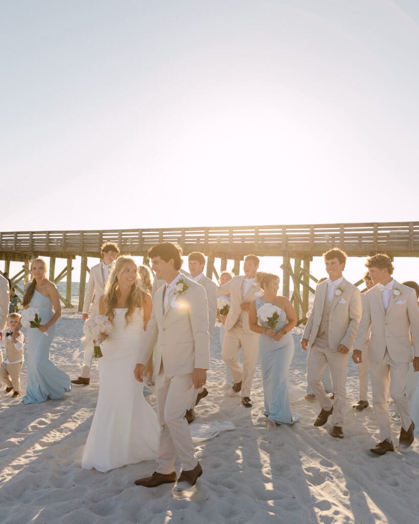 bridal party photo on beach at sunset